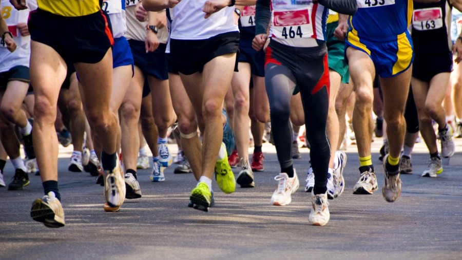 detail of the legs of runners at the start of a marathon race
